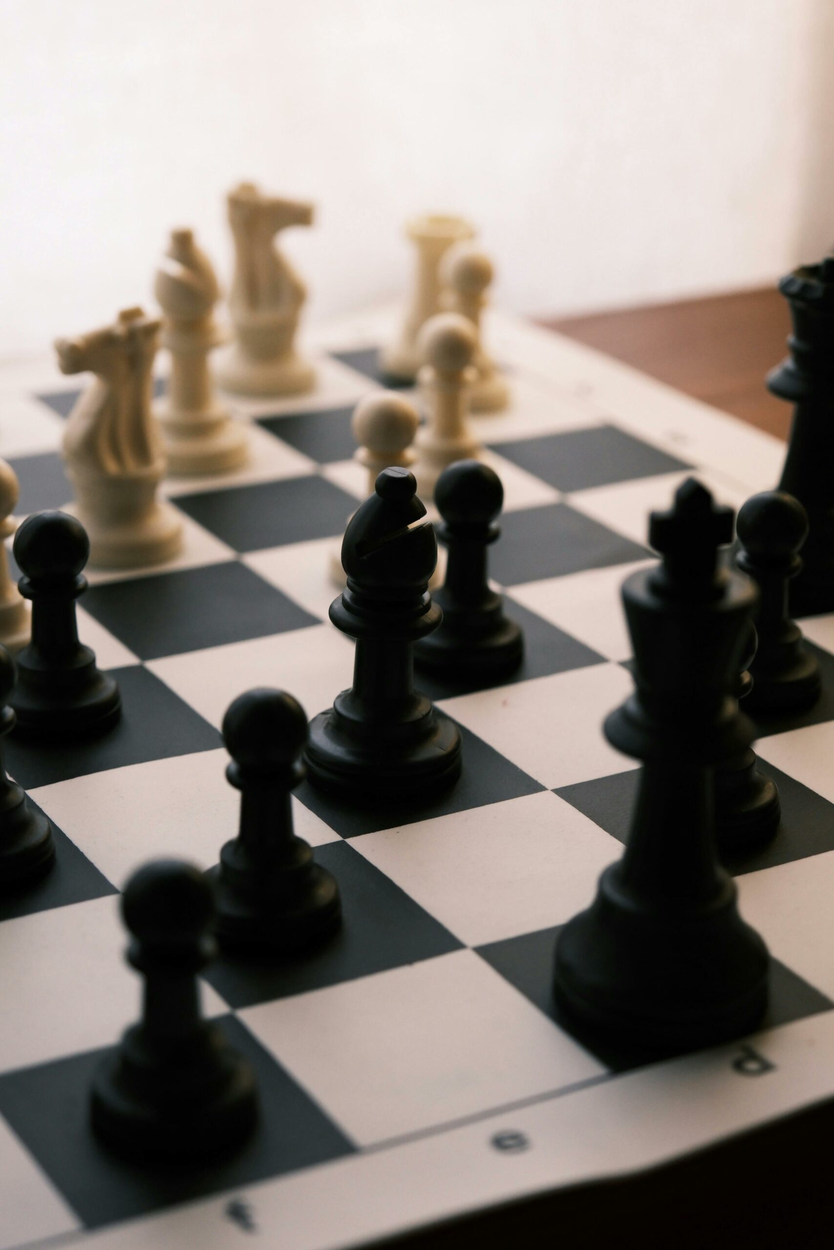 Close-up of a chess board with pieces in strategic play, creating a classic chess scene.